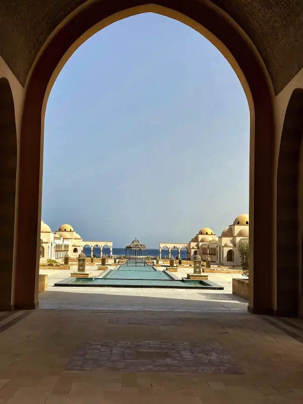 An archway framing the pool beyond