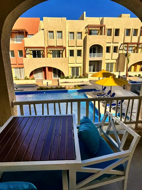 A private balcony table looking down over the pool