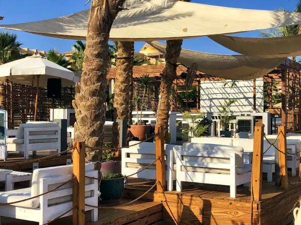 Shaded cabanas and daybeds on the sand