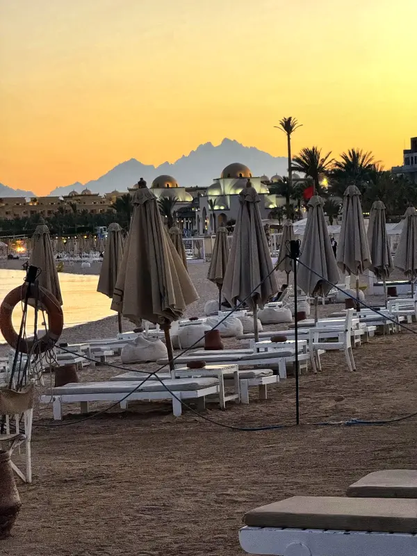 Parasols on the beach as the sun goes down
