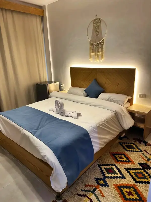 Double bed with bedside lamps lit