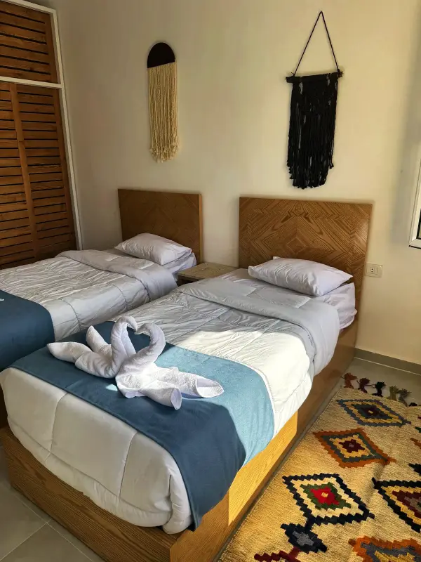 Twin beds made up with folded towels