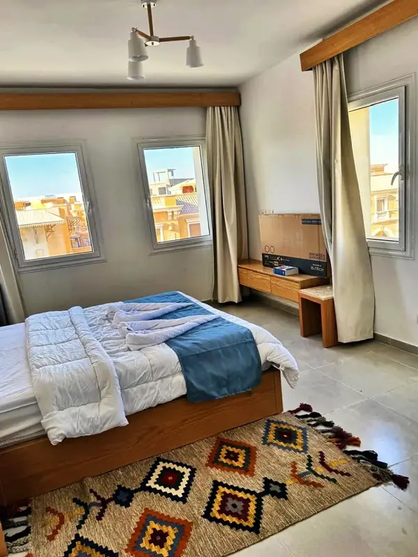 A bedroom with windows on two sides
