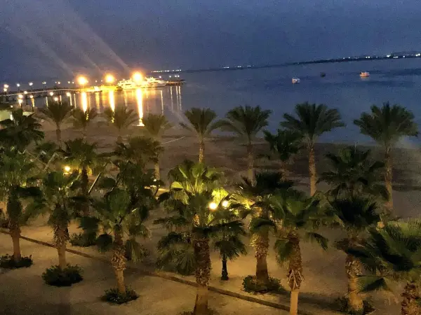 Lights along the shore and the sea at dusk