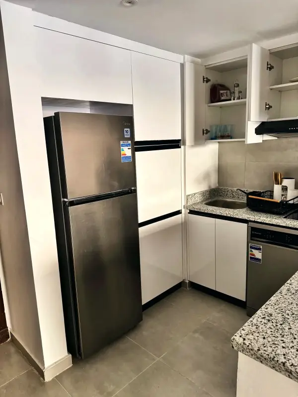 Kitchen with full-size fridge, oven and hob