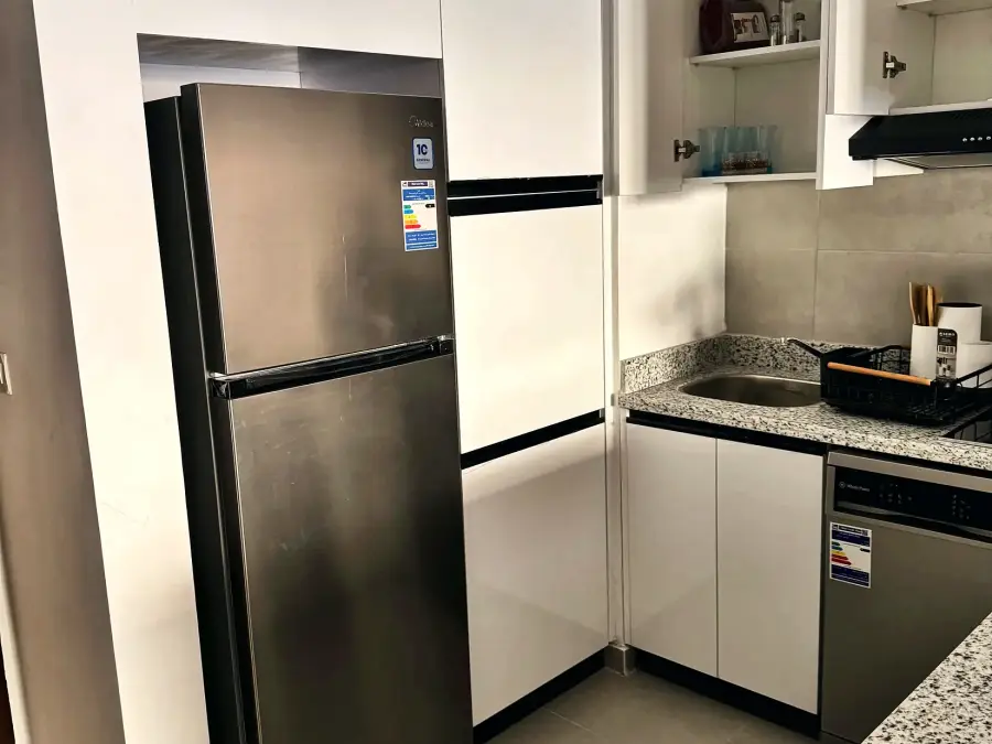 Kitchen with full-size fridge, oven and hob