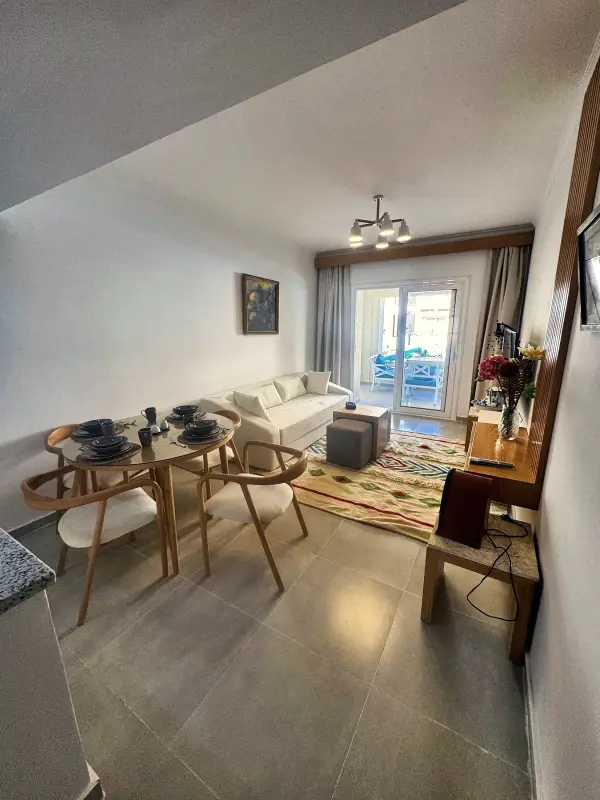 Living room with sofa, dining table and natural light