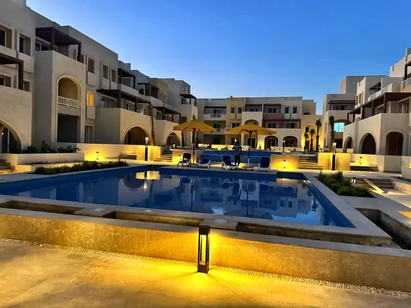 The pool and courtyard lit in the evening