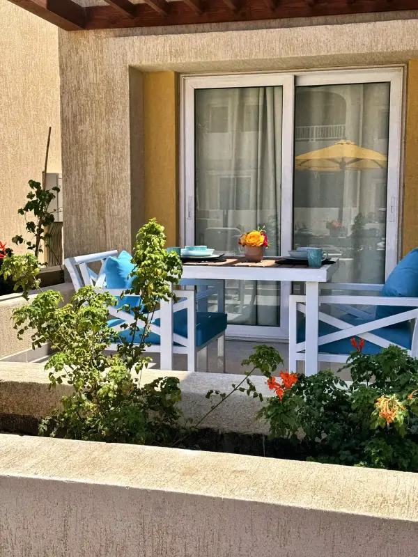 Table and chairs on a planted private terrace