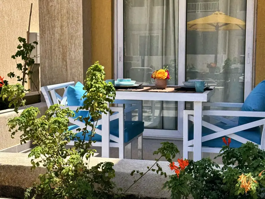 Table and chairs on a planted private terrace