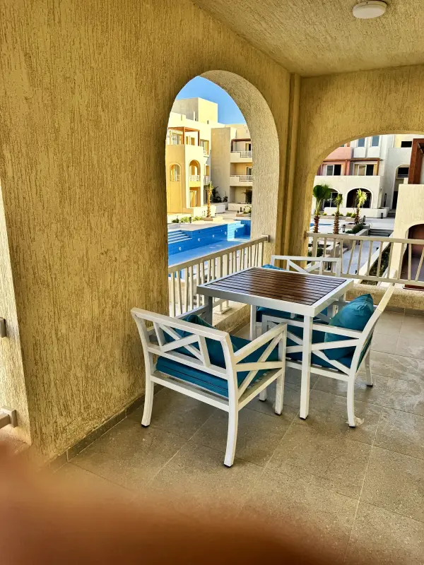 Dining table on the terrace, framed by an arch